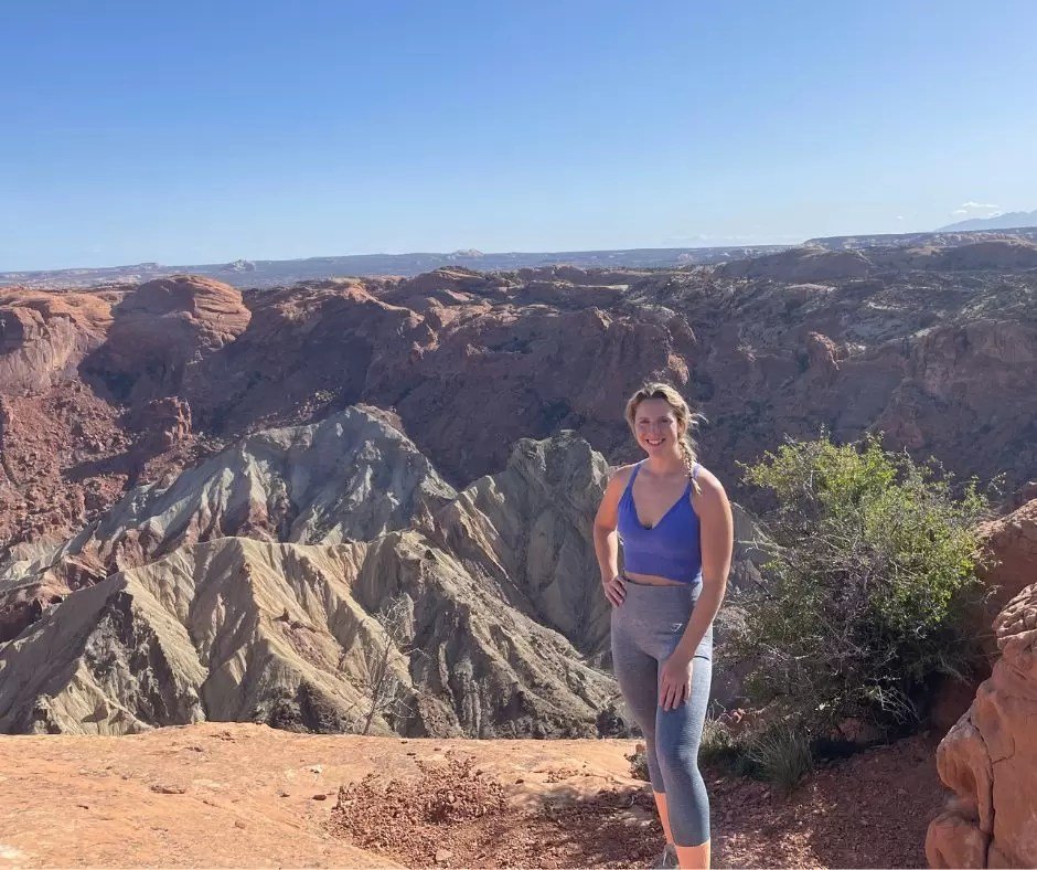blonde girl at upheaval dome second overlook in canyonlands national park utah
